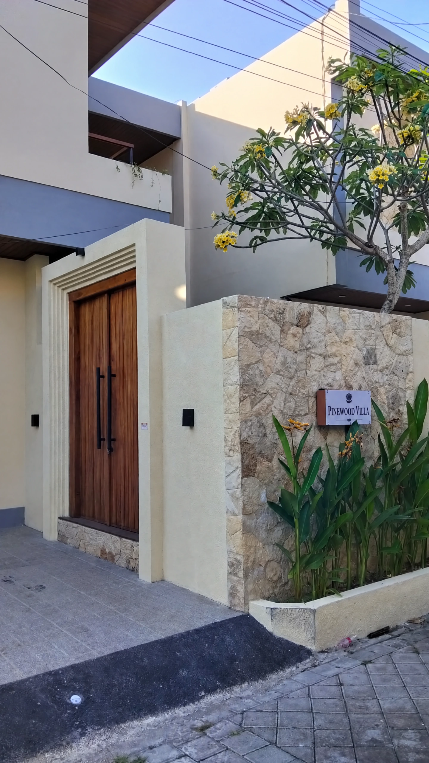 Pinewood Villa's tropical stone facade and entrance in Canggu, Bali